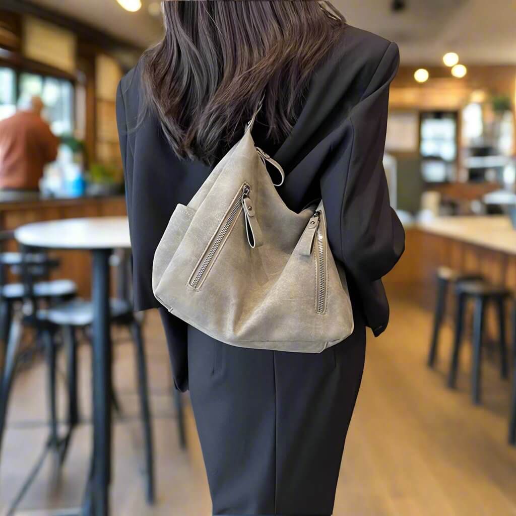 Woman wearing black jacket with CHRISTINA SHOULDER BAG in casual setting