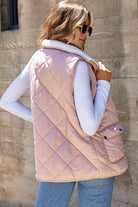 Woman wearing a REVERSIBLE RETREAT VEST! in pink sherpa lined quilted design.