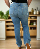 Judy Blue Irena bootcut jeans in plus sizes, showcasing the back view with a casual kitchen background.