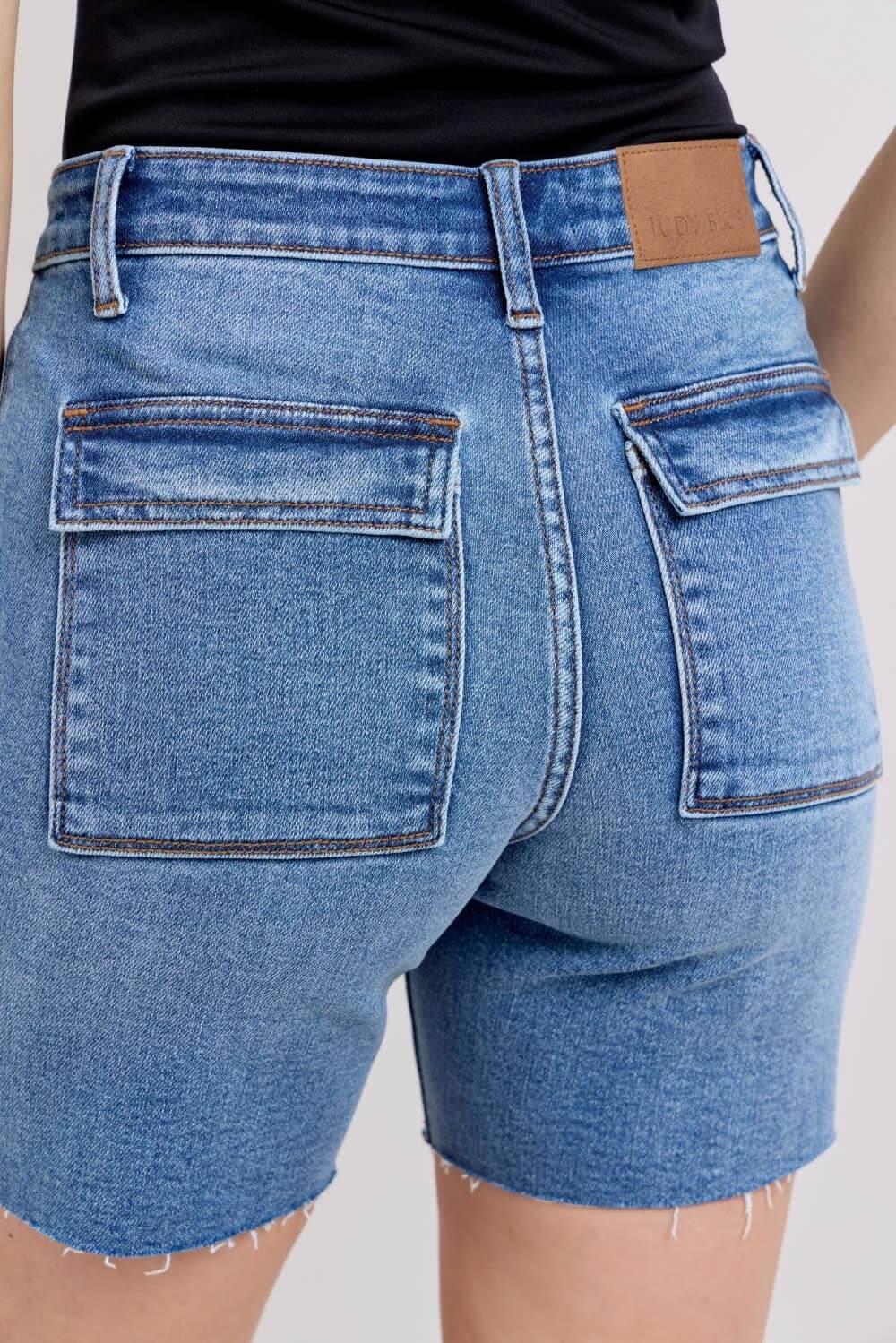 JUDY BLUE MIDRISE DAKOTA SHORTS featuring back flap pockets and mid-rise fit for stylish everyday wear.