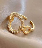 Gold-tone cocktail ring with sparkling Cubic Zirconia, featuring an adjustable fit for elegance and style.