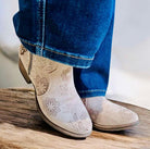 Light gray Very G Drift Bootie with floral print and 1.5" heel in faux suede, styled with jeans for comfort and fashion.