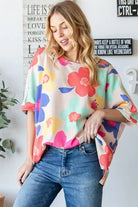 Floral oversized waffle knit top in vibrant colors, perfect to add whimsy to any outfit.