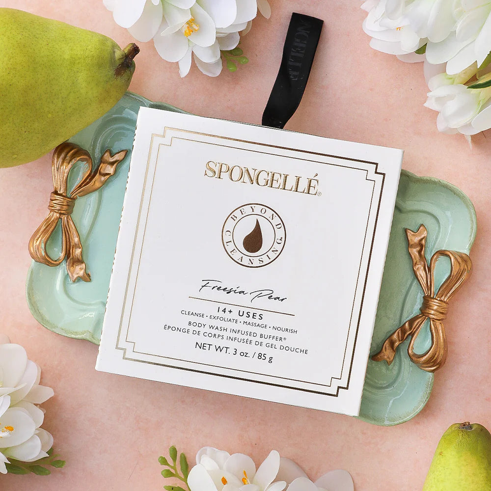BEYOND CLEANSING FREESIA PEAR by Spongelle packaged in a decorative tray with flowers and fruit, showcasing its luxurious design.