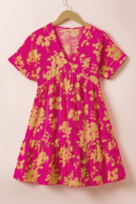 Chic summer dress in vibrant pink with floral print and batwing sleeves, perfect for all body types.