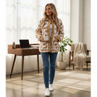 HONEY BLOSSOM SHERPA JACKET worn by a model, showcasing a light beige floral pattern with cozy texture in a stylish setting.