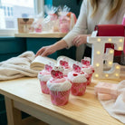 Too Cute to Eat Valentine Sock Cupcakes displayed on a table, featuring pink and red designs, ready for gifting.