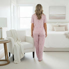 FESTIVE FRILLS LOUNGE SET featuring a soft pink pajama set with floral design, perfect for cozy relaxation.