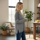 MAIN STREET MOMENTS Top (espresso) worn by a woman in a modern kitchen, showcasing its stylish ribbed design.