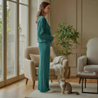 LAKEHOUSE LUXE PANTS SET model in sea teal textured round neck sweatshirt and high-waist pants, alongside a cat.