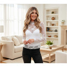 FLORAL FROST MESH TOP in white with floral pattern, long sleeve, worn by a model in a stylish interior.