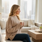 Woman enjoying morning coffee in a cozy living room wearing the MAIN STREET MOMENTS Top (mocha latte) in a warm setting.