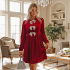 SPARKLE SEASON VELVET DRESS (Holiday Red) featuring rhinestone bow accents, perfect for Christmas.