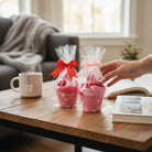 Too Cute to Eat Valentine Sock Cupcakes presented in pink cupcake cups with decorative bows.