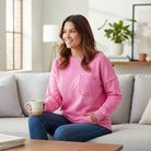 CLOUD NINE CREW pullover in pink, featuring exposed seams and a raw edge pocket for relaxed comfort and everyday style.