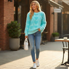 LOVE AT FIRST SIGHT SWEATER worn by a woman in a cozy outdoor setting with a heart pattern.
