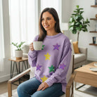 MARDI GRAS STAR PULLOVER in lavender with sequined star patches worn by a woman holding a cup.