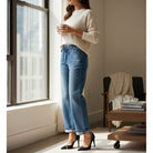 Model wearing DARCY JEANS by Risen, showcasing elastic waistband and cuffed hem for a relaxed fit.