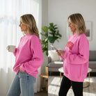 DOUBLE THE LOVE REVERSIBLE PULLOVER displayed in bright pink with LOVER script and heart graphic on each side.