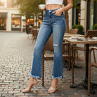 FAE JEANS by Risen high-rise flare jeans in medium-light wash with frayed hem, styled for effortless, trendy looks.