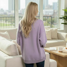 Back view of model wearing the SOFT HORIZONS CREWNECK in lavender, featuring a relaxed fit and fleece lining.