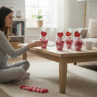 Woman admiring Too Cute to Eat Valentine Sock Cupcakes on a cozy table in a bright room.