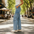 RIBBON ROUTE JEANS - BiBi styled in a trendy outdoor setting, showcasing unique bow tie accents and relaxed fit.