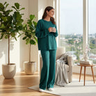 Woman wearing LAKEHOUSE LUXE PANTS SET, a sea teal textured sweatshirt and loose drawstring pants, in a cozy setting.