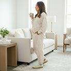 Woman enjoying coffee in SOFT TERRAIN 2 pc Lounge Set with soft gray and cream camo print, relaxed style in a cozy living room.