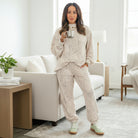 Woman enjoying coffee in the SOFT TERRAIN 2 pc Lounge Set, featuring soft gray and cream camo print for effortless comfort.
