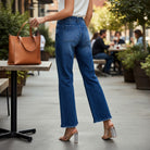 ALIZA JEANS by Risen worn by a model outdoors, showcasing high-rise flare and patch pockets in a stylish setting.