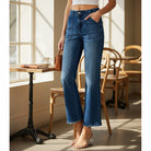 ALIZA JEANS by Risen high-rise flare denim with patch pockets, styled in a cafe setting.