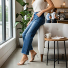 ALIZA JEANS by Risen model showcasing high-rise flare denim in a stylish café setting.