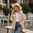 Café Cream Suede Jacket worn by a woman sipping coffee outdoors, showcasing its stylish design and cozy fit.