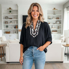 FIERCE FOCUS TOP featuring a trendy leopard patchwork trim, flattering V-neckline, and dolman half sleeves in a stylish black blouse.