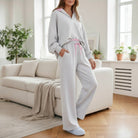 SWEET SOFTNESS 2 PIECE SET featuring a light grey pullover with pink trim and drawstring pants for cozy comfort.