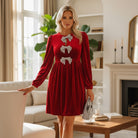 SPARKLE SEASON VELVET DRESS (Holiday Red) with rhinestone bow accents, perfect for festive occasions.