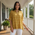 Model wearing the DOT DIRECTIONS TOP - Umgee (gold) in a stylish outdoor setting.