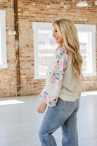 Model showcasing the Vanilla Skye Top with floral patchwork, balloon sleeves, and a chic ribbed design in a stylish setting.