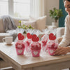 Too Cute to Eat Valentine Sock Cupcakes wrapped in cellophane with heart toppers on a table.