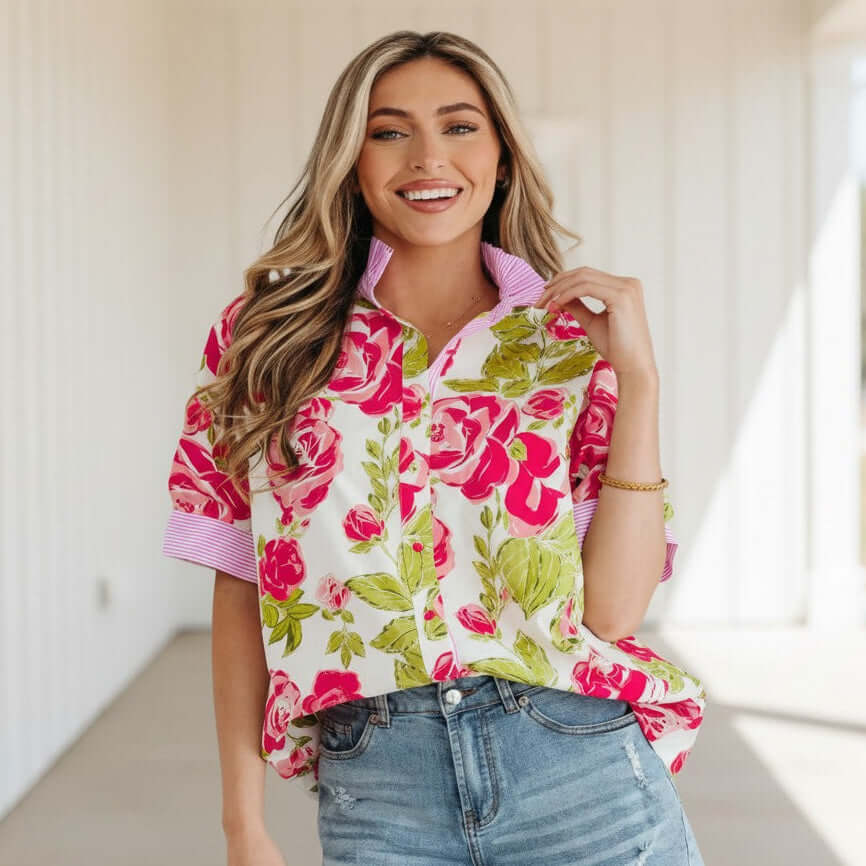 Model wearing a SPRING STATEMENT TOP with a vibrant floral print and contrasting striped trim.