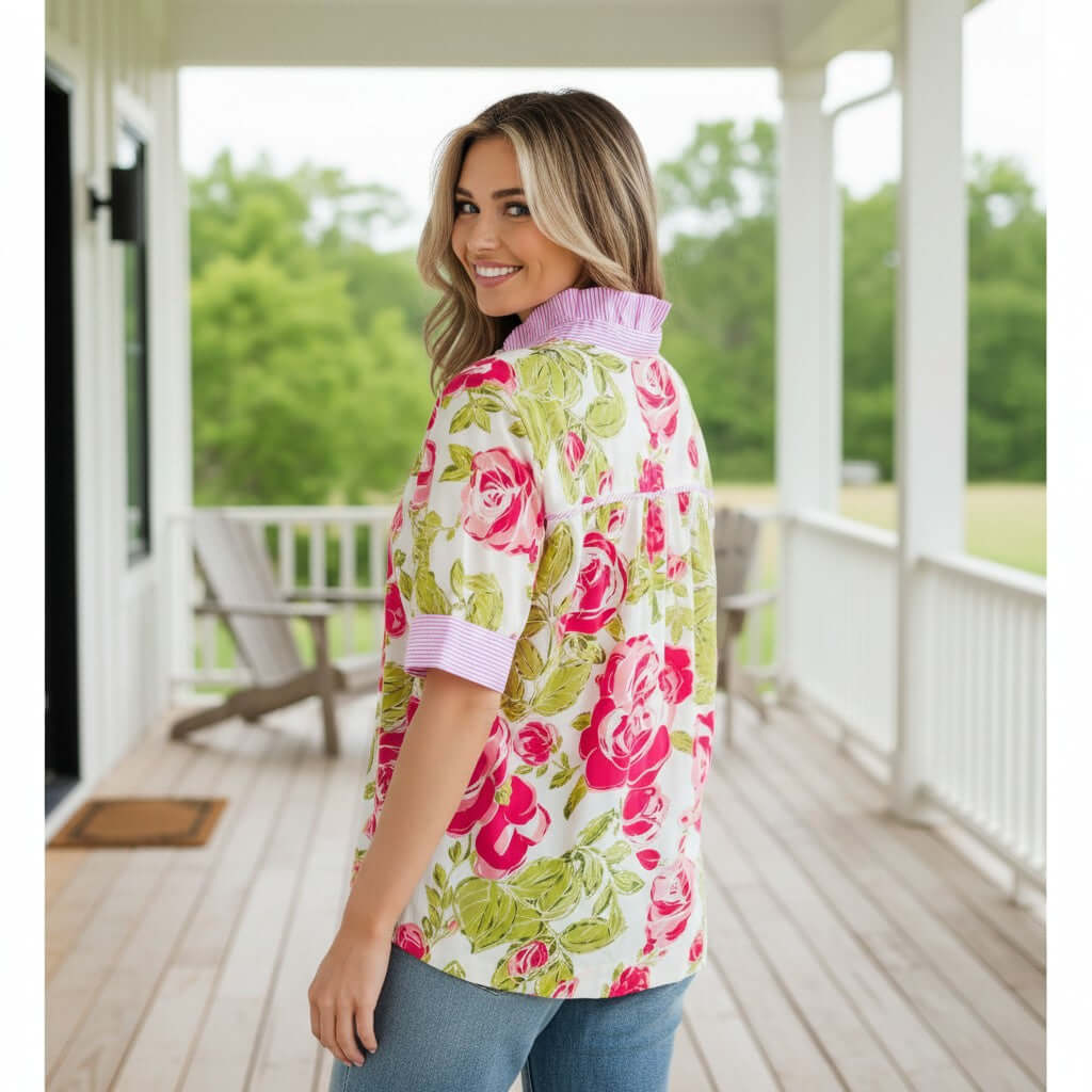 Woman wearing SPRING STATEMENT TOP with floral print and striped trim, showcasing the frilled collar style.