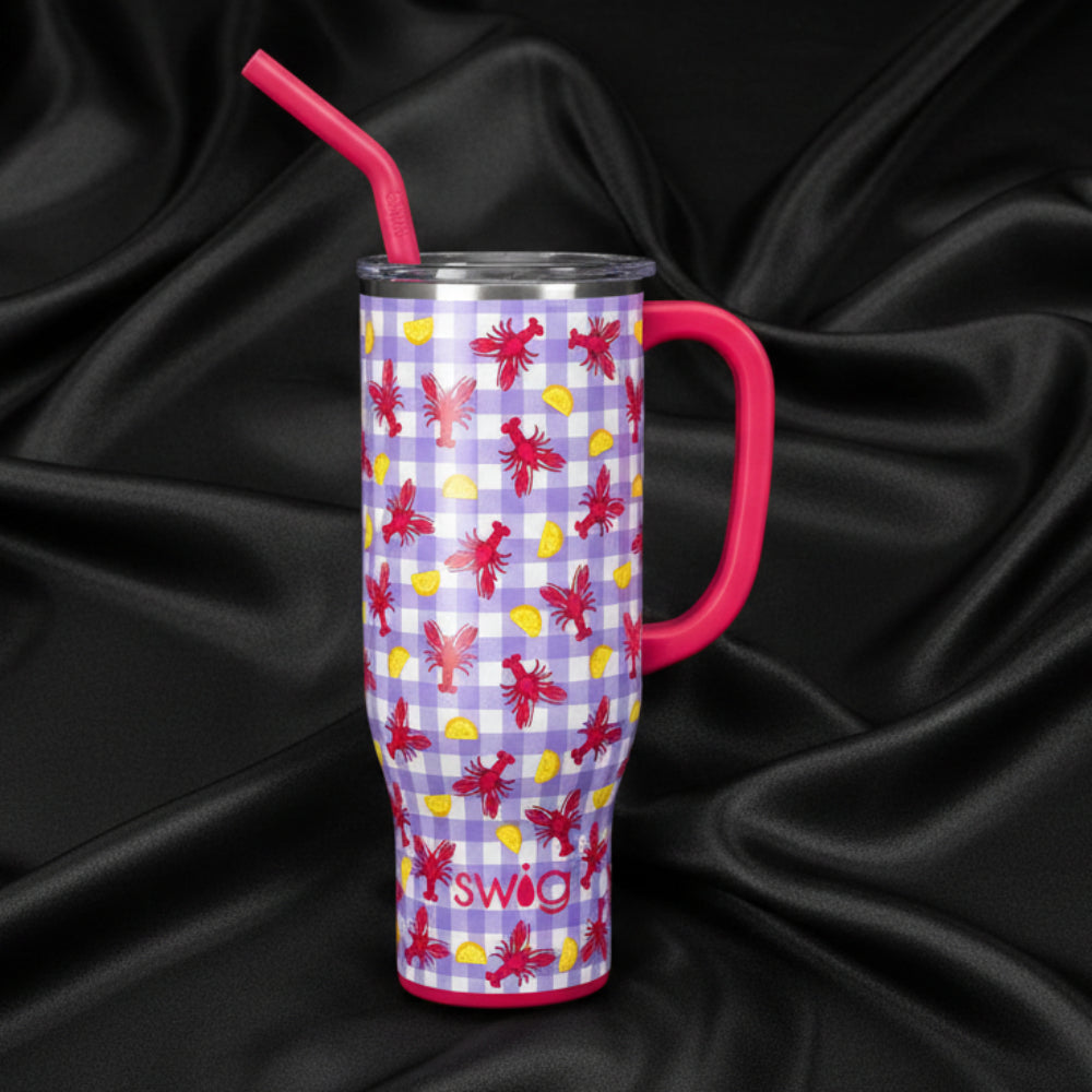LET THE GOOD TIMES BOIL - 40 OZ TRAVEL MUG - Swig with a crawfish and lemon design and pink straw on a dark background.