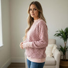 Model wearing LAZY DAY LEOPARD CREWNECK pink leopard print sweatshirt, showcasing its relaxed fit and cozy style.