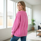 Model wearing a pink CLOUD NINE CREW pullover, showcasing its relaxed fit and cozy style by Zenana.